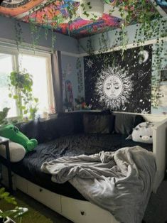 a bed room with a large window and a sun mural on the wall above it