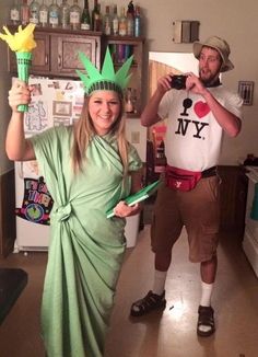 two people dressed up as the statue of liberty and lady liberty, one in a green dress