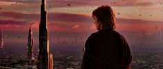 a man standing on top of a tall building in front of a sky filled with clouds