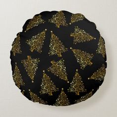 a black and gold pattern on a round pillow