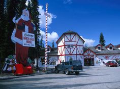 a truck parked in front of a santa clause sign