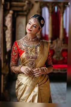 a woman in a gold and red sari