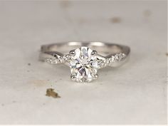 a white gold engagement ring with an oval cut diamond