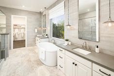 a large bathroom with two sinks and a tub