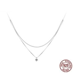 Legara V-Neck Layer Necklace is a charming spin on a standard layer or pendant necklace. The platinum plating over 925 sterling silver makes this necklace hypoallergenic, waterproof, and tarnish resistant. Pendant: 925 silver with gorgeous high-grade inlaid cubic zirconia designed to look just like a real diamond. Chain style: Box chain and ball chain combo is unique and elegant. Silver Cubic Zirconia Charm Necklaces, Tarnish Resistant, Fine Jewelry Silver Necklaces For Layering, White Gold Sterling Silver Necklace For Layering, Silver Tarnish Resistant Charm Necklaces With Cubic Zirconia, Fine Jewelry Silver Double Strand Necklace, Silver Tarnish Resistant Fine Diamond Necklace, Silver Tarnish-resistant Fine Jewelry Diamond Necklace, Silver Tarnish Resistant Charm Necklace For Layering, Silver Tarnish-resistant Charm Necklace For Layering