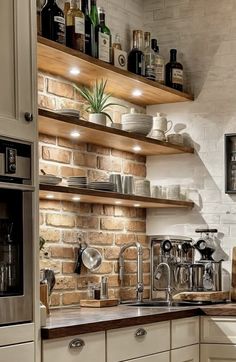 a kitchen with white cabinets and brick walls