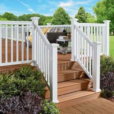 an outdoor deck with white railings and wooden steps