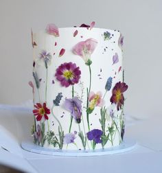 a white cake with flowers painted on it