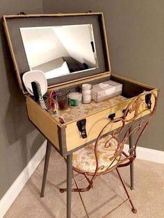 an old vanity table with a mirror on top and other items sitting in the drawer