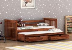 a child's bed with two drawers underneath it