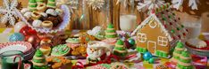 a table topped with lots of different types of cookies and desserts covered in icing