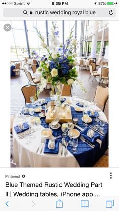 an image of a table set for a wedding reception with blue and white flowers on it