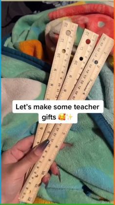 someone is holding three wooden rulers in front of the text let's make some teacher gifts