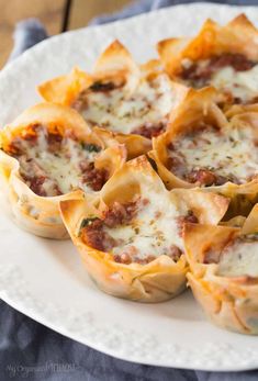 several mini pizza shells on a white plate