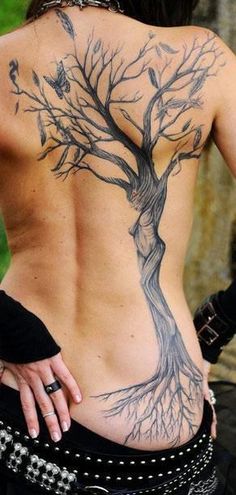 a woman with a tree tattoo on her back