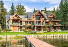 a large house sitting next to a body of water