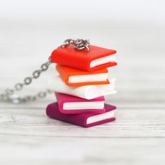 a stack of books sitting on top of each other with a chain attached to it