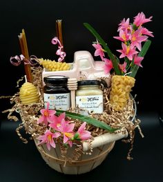 a basket filled with food and flowers on top of a table