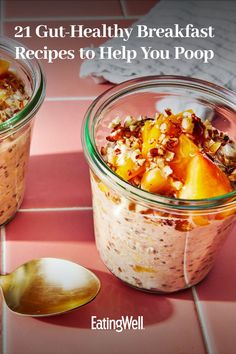 two glass jars filled with breakfast food on top of a pink tile floor next to a spoon