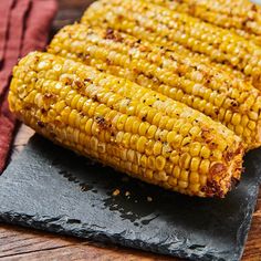 grilled corn on the cob on a slate platter