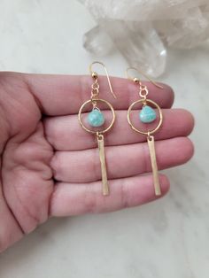 Nova Earrings featuring the Amazonite stone. These gems are such a pretty color! They are light and can be worn with a t-shirt and jeans or with a summer dress. The materials are your choice of 14k Gold Filled or Sterling Silver. Each piece is hammered for texture and shape. The length of the earrings are about 2 in. These are handmade and may vary slightly as well as the stones as they are natural. Thank you! Amazonite Stone, T Shirt And Jeans, Pretty Colours, Earring Necklace, Summer Dress, Gold Filled, Gems, Texture, Sterling Silver