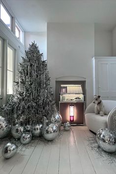 a living room filled with silver ornaments and a christmas tree