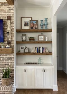 the shelves in this room are filled with books and vases on top of them