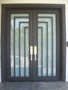 a black double door with glass panels on the outside