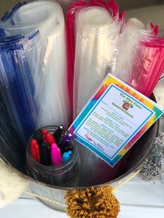 a basket filled with lots of different types of pens and pencils on top of a table