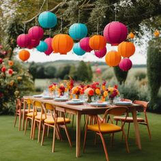 a long table with colorful paper lanterns hanging from it