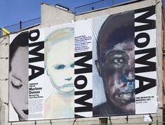 a large advertisement on the side of a building with multiple faces and words painted on it