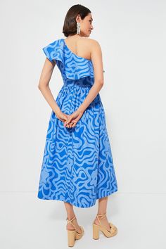 Oliphant's vacation-ready pieces are characterized by breezy silhouettes and vibrant colors.The vacation look of our dreams, the Ashbury Blue Maxi Dress features a stunning print that has us in the mood for a daiquiri. With a ruffle that cascades along the asymmetrical neckline and a ruched skirt with trapunto stitched hem this dramatic silhouette makes a real statement — and its lightly structured cotton poplin fabric ensures it is both breezy and packable. Style with espadrilles and a clutch f Dramatic Silhouette, Ruffle Maxi Dress, Blue Maxi Dress, Vacation Looks, Cotton Poplin Fabric, Ruched Skirt, Skirt Maxi, Cocktail Attire, Romantic Evening