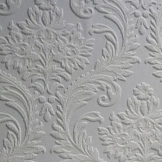 white wallpaper with an intricate design on the back and side of it's surface