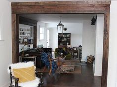 a living room filled with furniture next to a doorway