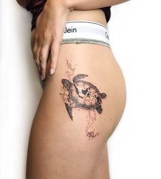 a woman's thigh with a tattoo of a turtle on the side and words written below it