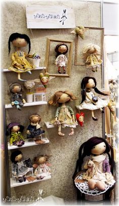 there are many dolls hanging on the wall