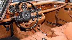 the interior of an old car with wood trim