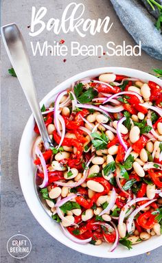 a white bean salad with red onions and greens