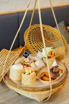 a bamboo basket filled with food on top of a wooden table