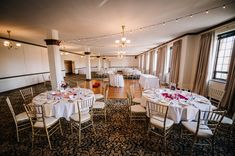 an empty banquet room with tables and chairs