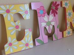 wooden letters with flowers painted on them