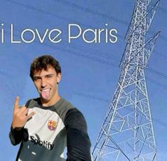 a man making a funny face in front of an electric tower with the words i love paris on it