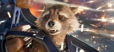 rocket racoon is riding in the back of a rocket ship with an angry look on his face