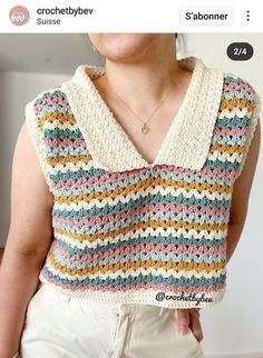 a woman is wearing a crocheted top and has her hand on her hip