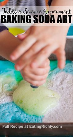 a child is making homemade baking soda art with the words toddler science experiment baking soda art