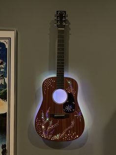 a wooden guitar is hanging on the wall