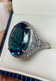 Natural London Blue Topaz Ring Description Persian Design#230 Made-Custom This is a brand new stunning Art Deco/Vintage designed sterling silver filigree 18ct oval Natural/Genuine London Blue Topaz ring. The oval full cut high-quality VS to VVS Topaz is 18mm (just shy of 3/4th of an inch) by 13mm (1/2 inch) in dimension... This ring is 21mm NS on the finger. The inside of the band is marked 925 for sterling. Notice the beautiful filigree swirl like the craftsmanship of the silver setting. This l Antique Oval Sapphire Ring For Formal Occasions, Oval Topaz Ring For Formal Occasions, Elegant Oval Diamond Cut Topaz Ring, Classic Oval Topaz Ring Hallmarked, Antique Oval Topaz Ring For Formal Occasions, Formal Oval Hallmarked Topaz Ring, Classic Oval Topaz Ring, Formal Oval Topaz Ring Hallmarked, Formal Oval Topaz Gemstone Ring