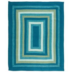 a blue and green rug with squares on it