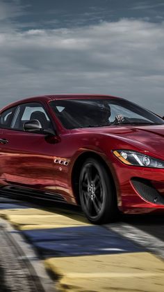 a red sports car driving on a race track