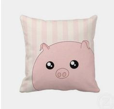 a pink pillow with a pig face on the front and side of it, sitting on a white background